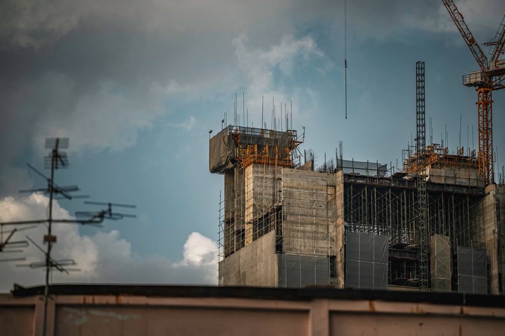 Building under construction with scaffolding and crane