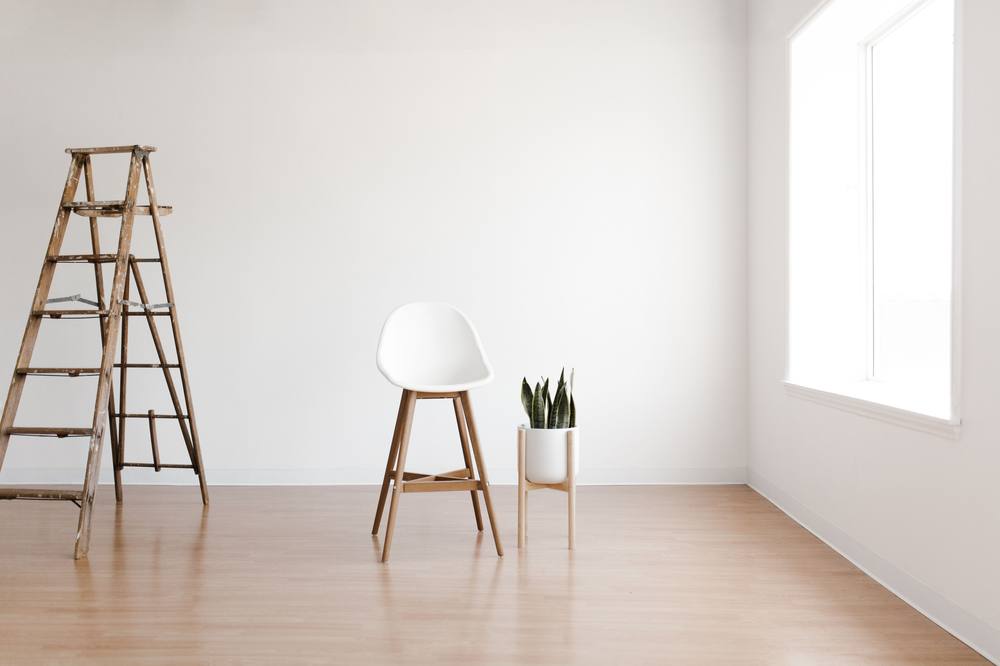 Empty freshly finished room with a ladder and chair